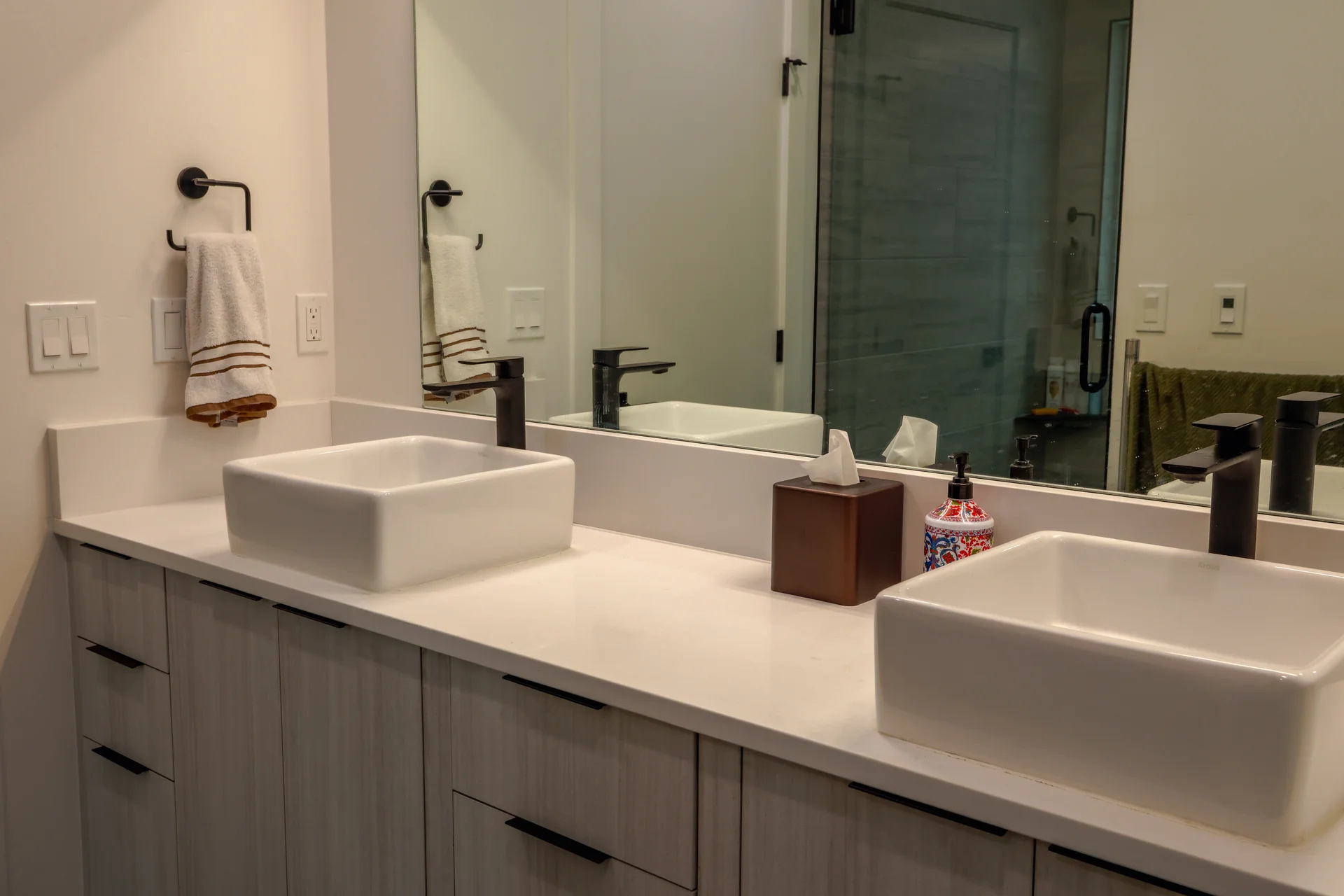 Master bathroom with dual vessel sinks and modern fixtures
