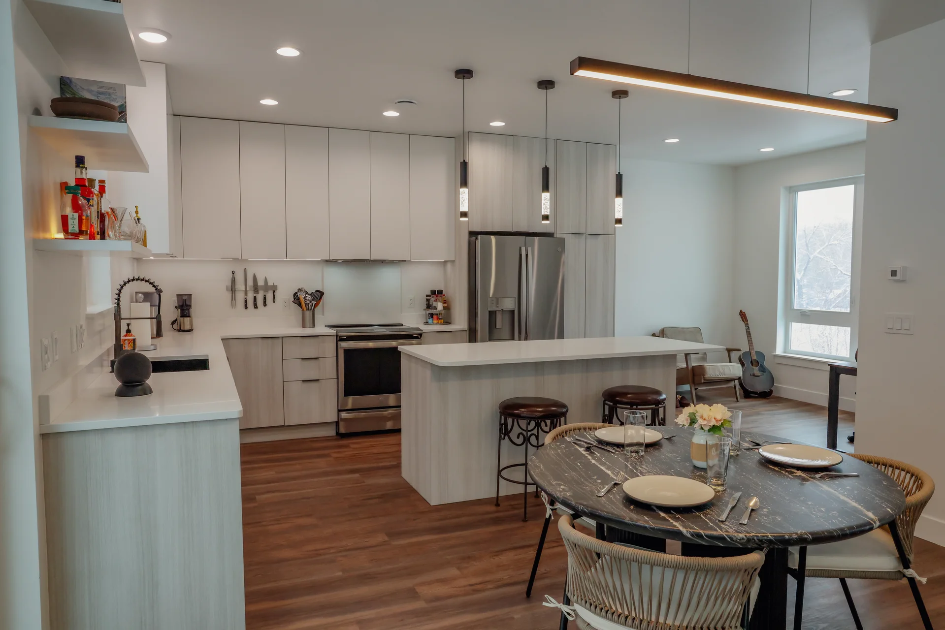 Modern kitchen with island, pendant lights, and breakfast bar
